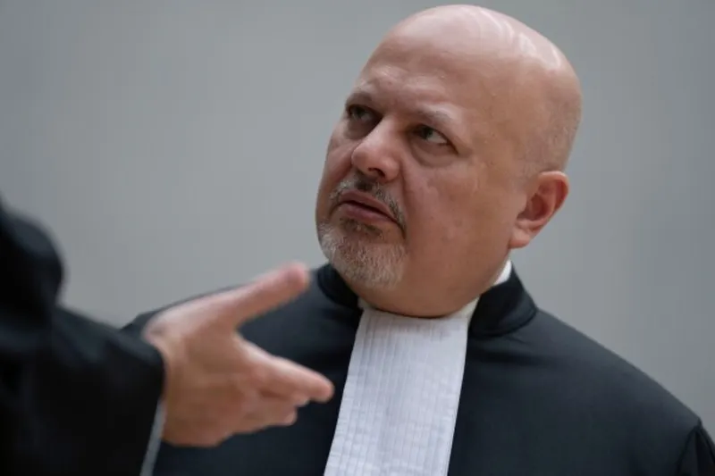 Bărbat chel, cu barbă albă, în robă cu guler alb, ascultând pe cineva care gesticulează
