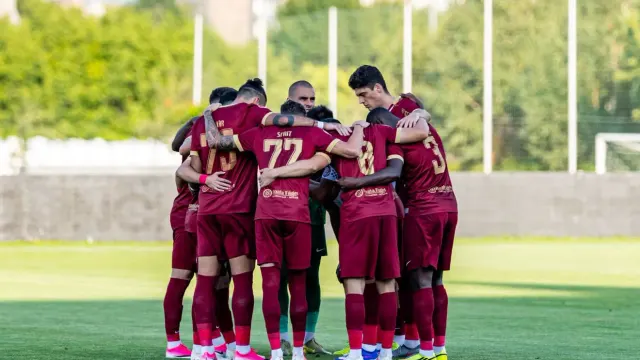 Fotbaliștii CFR Cluj, în echipament vișiniu, strânși în cerc pe gazon