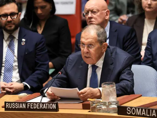 Bărbat cu ochelari citind de pe o foaie la masa cu plăcuța „Russian Federation”, la ONU