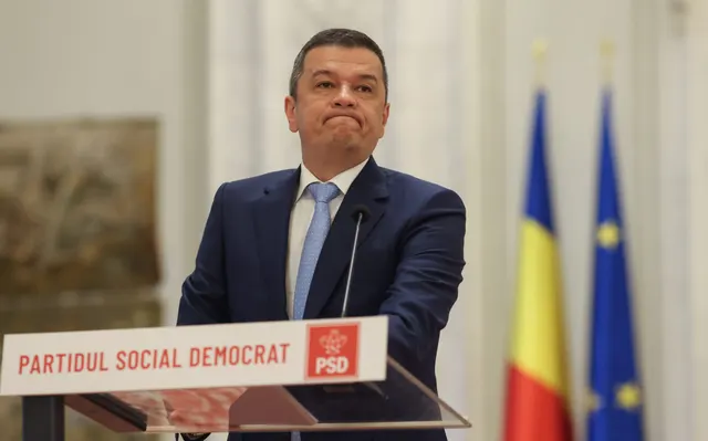 Sorin Grindeanu la pupitrul Partidului Social Democrat, între drapelele României și UE
