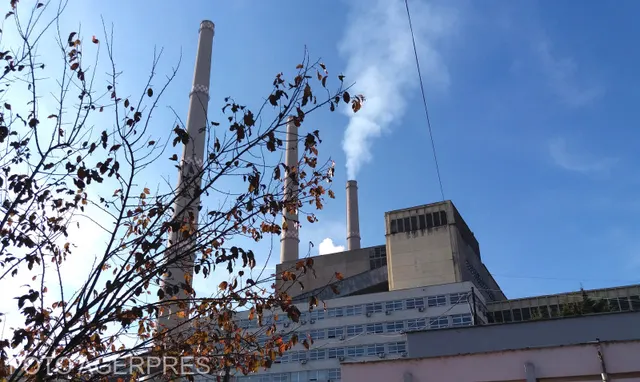 Termocentrala Mintia, cu coșurile înalte și un fum alb, sub cer albastru